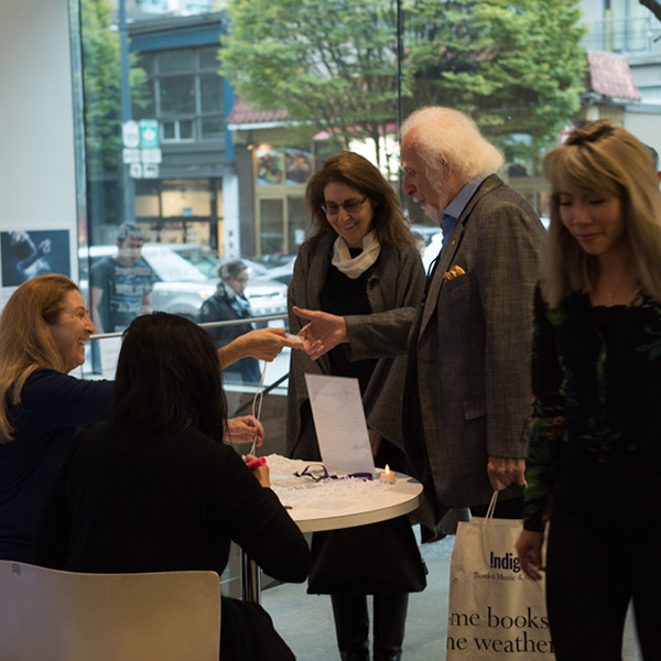 People receive tickets from volunteers in the lobby of Scotiabank Dance Centre