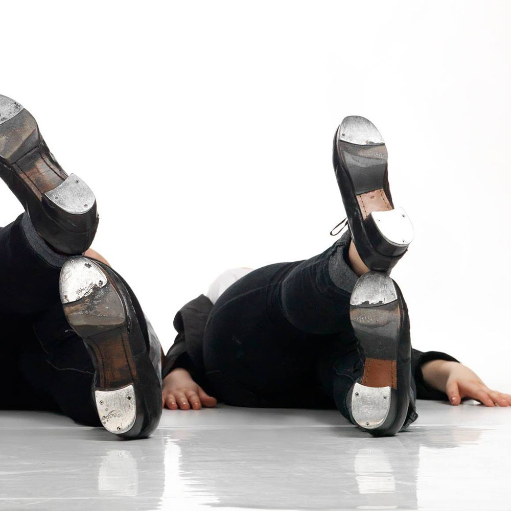 Two sets of feet wearing tap shoes