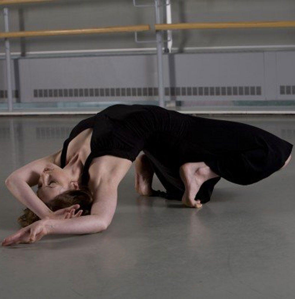Julia Carr poses on floor during dance performance