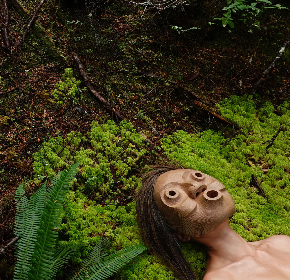 Indigenous mask lying in the forest