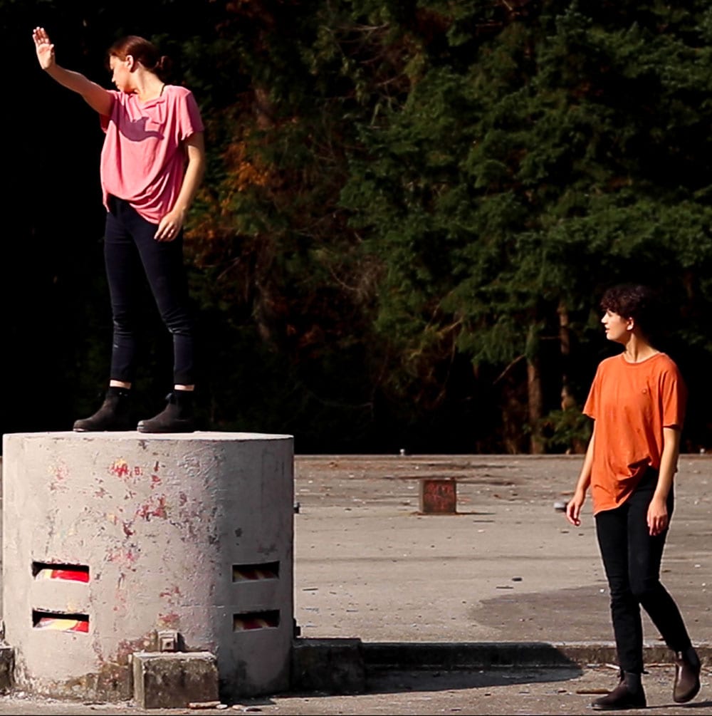Dance artists perform in an industrial lot