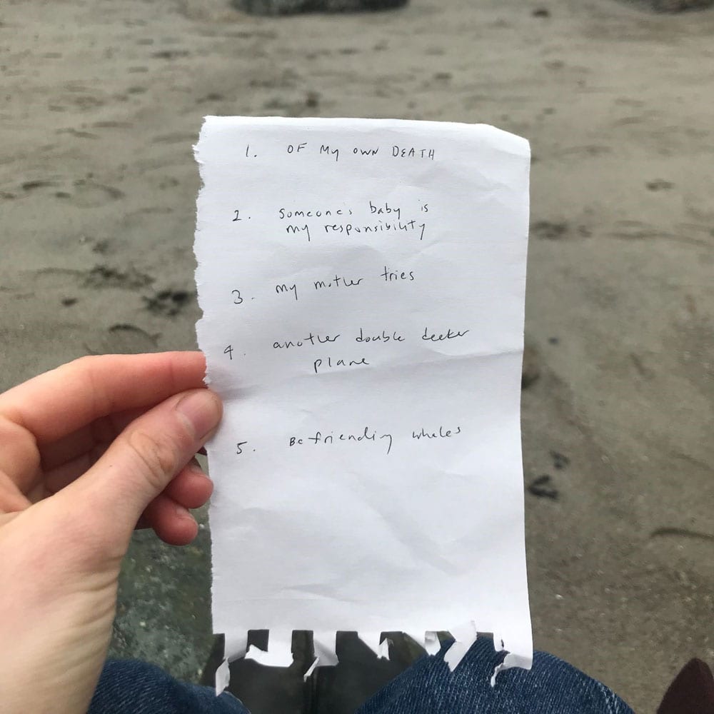 photo of list of promps from a shared practice of dance artists with sand behind it