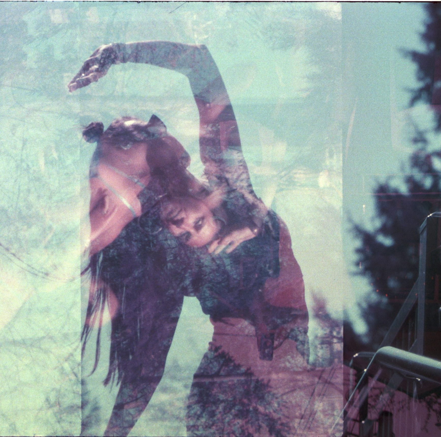 A dance artist arches backward with her arm above her head. She is wearing sunglasses and the image has a filter overlay showing her face in a different orientation.